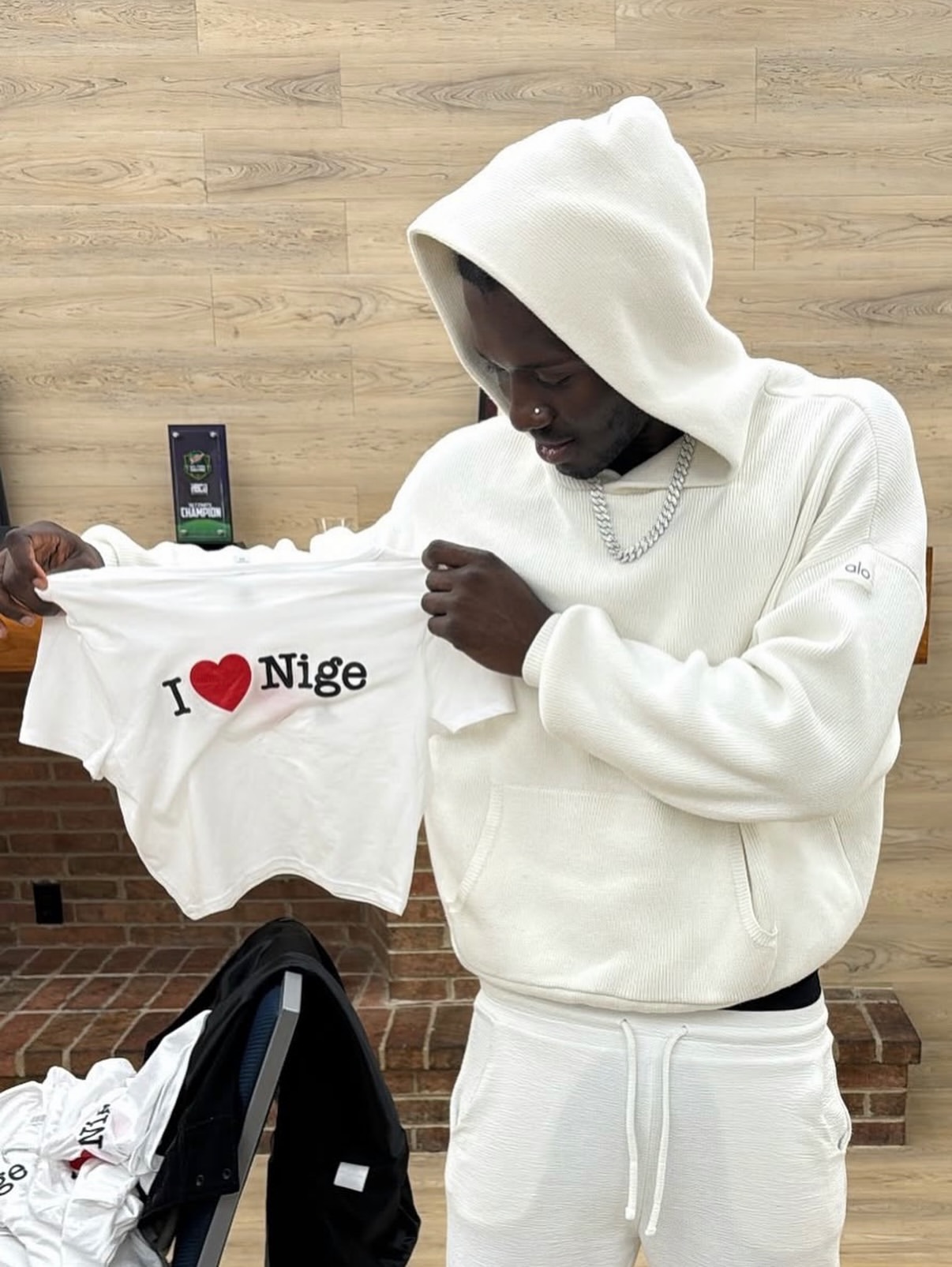 NIGE holding an I Love Nige shirt